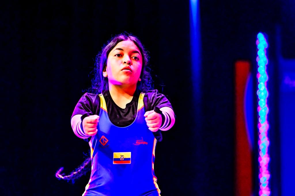 Ecuadorian para powerlifter in a blue national uniform preparing to compete