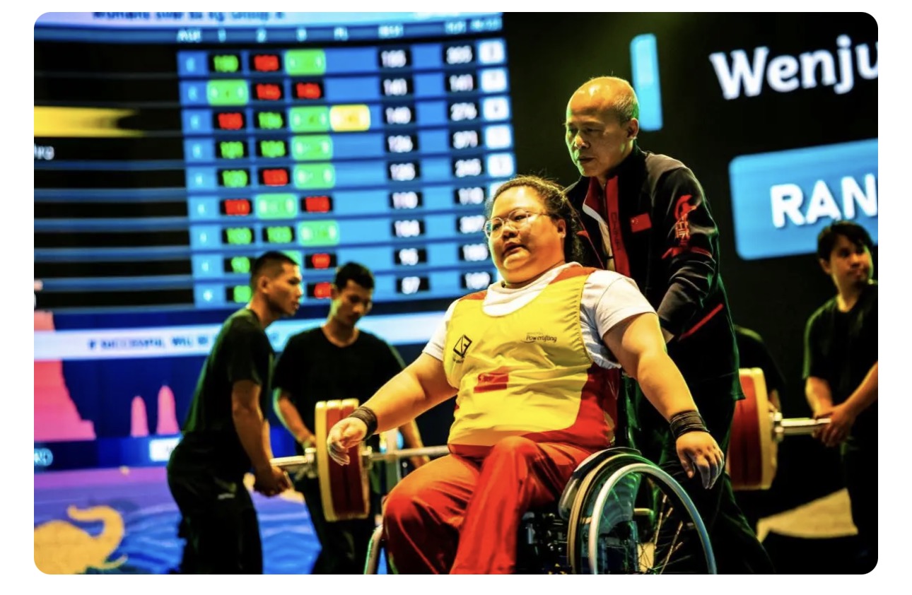 Para powerlifter in a yellow and red competition suit